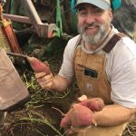 Jeremy holding sweet potatoes.